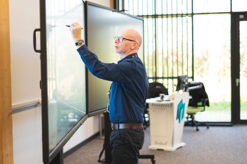 Associate Professor Peter Metcalfe delivering training - writing on a digital white board