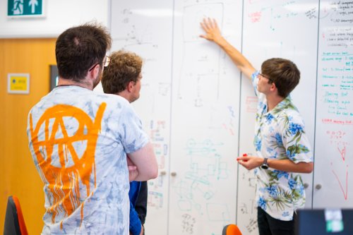 NMITE Students in a studio making calculations on a whiteboard