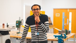 Sukhpreet Singh - MEng Integrated Engineering student - stood in NMITE engineering studio