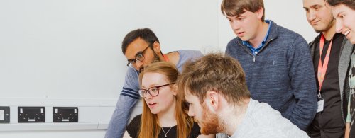 NMITE Students gathered around a laptop