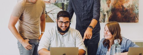 Professional students collaborating on a laptop